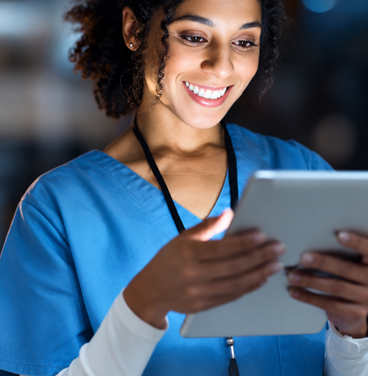 Healthcare provider smiling while charting on a tablet with BodySite